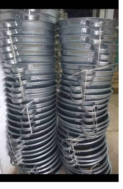 Galvanised basins and pans stacked — household goods